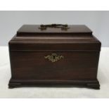 An mahogany Edwardian tea caddy with brass handle and lock. Inside is three equal compartments, a