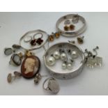 A collection of jewellery to include three hallmarked silver bangles, silver rings and earrings a