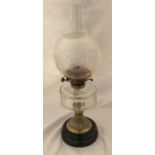 A Victorian oil lamp with a clear glass bowl with brass stem on slate base and acid etched shade.