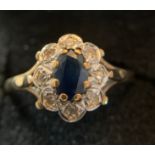 A 9ct sapphire and diamond cluster ring. Size L. 1.7gms weight.