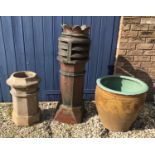 A tall crowned brown glazed chimney pot 106cm, a small limestone chimney pot 55cm and a large