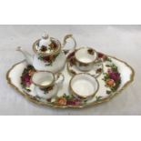 A Royal Albert Old Country Roses miniature Tea Service set to include a teapot 9.5cms h, tea cup and