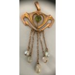 An Arts and Crafts Barnet Henry Joseph 9ct gold peridot and seed pearl pendant with 5cm drop. 1.