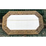 An embossed brass framed bevel edged wall mirror. 74cms w x 45cms h.Condition ReportUnpolished