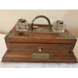 A late C19th oak ink stand with drawer to front and two glass inkwells lacking lids. 33cm x 22cms.