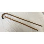 Two walking sticks. One with silver collar and tip Birmingham 1922-93cm L and one hazlewood cane