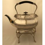 A hallmarked silver spirit kettle with reeded column sides on burner stand, E.H. London 1889.