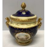 A Coalport signed blue ground and gilt lidded vase with a painted panel of a country scene near
