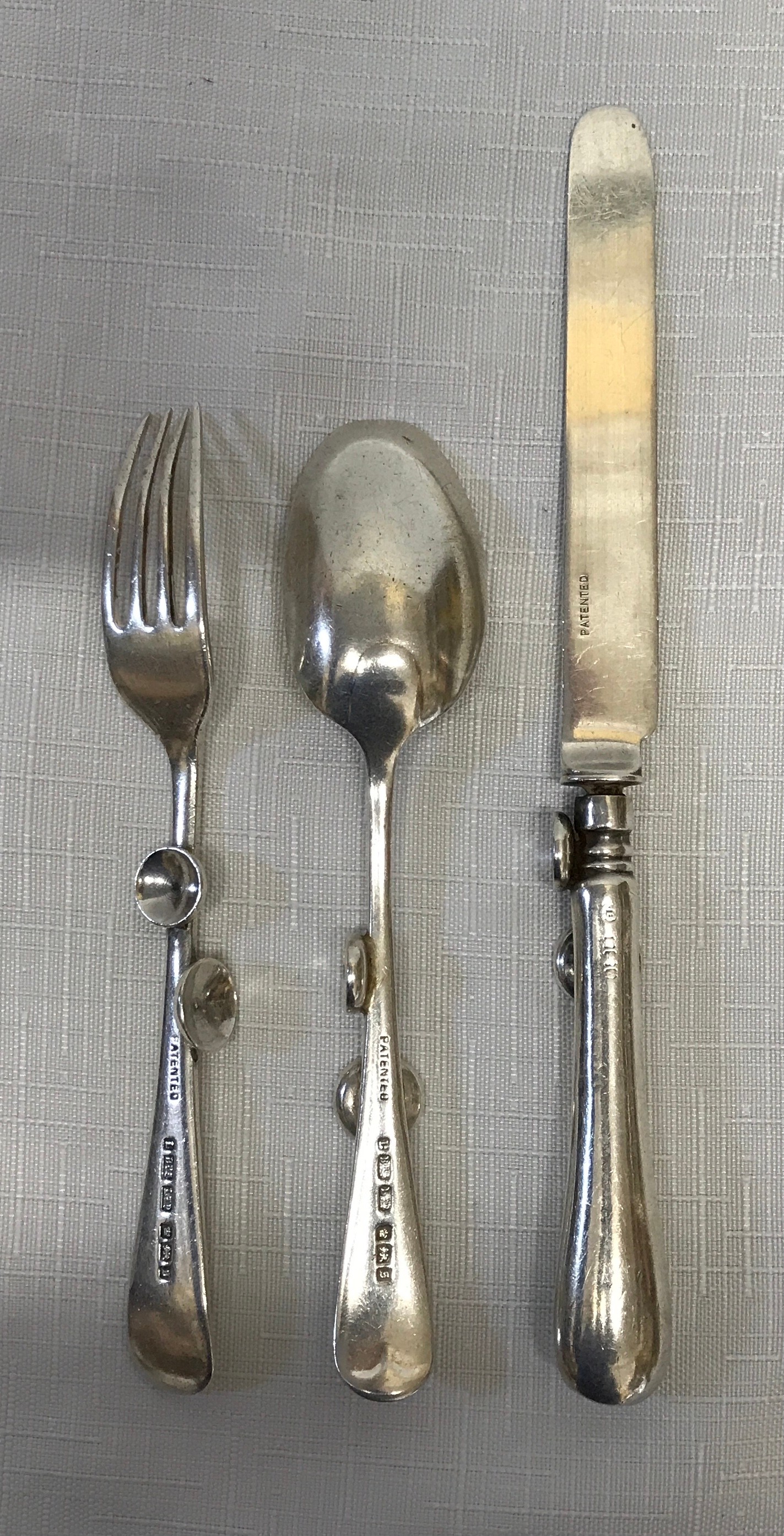 A Silver cutlery set, Sheffield 1910 L BRS Ltd with ergonomic design possibly for infants due to - Image 2 of 5
