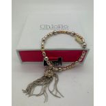 A Chlobo silver tassel bracelet marked .925 in original box with purchase receipt for £170 with a