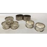 Seven silver napkin rings to include a set of three with pierced decoration I.S.G. Birmingham