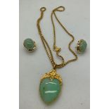 A jade and yellow metal heart shaped pendant and earrings. Earrings marked .585 (14ct gold). Pendant