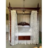 A 20thC carved hardwood four poster double bedstead. 5ft mattress size. Bed 160 w x 230 l x 245cms