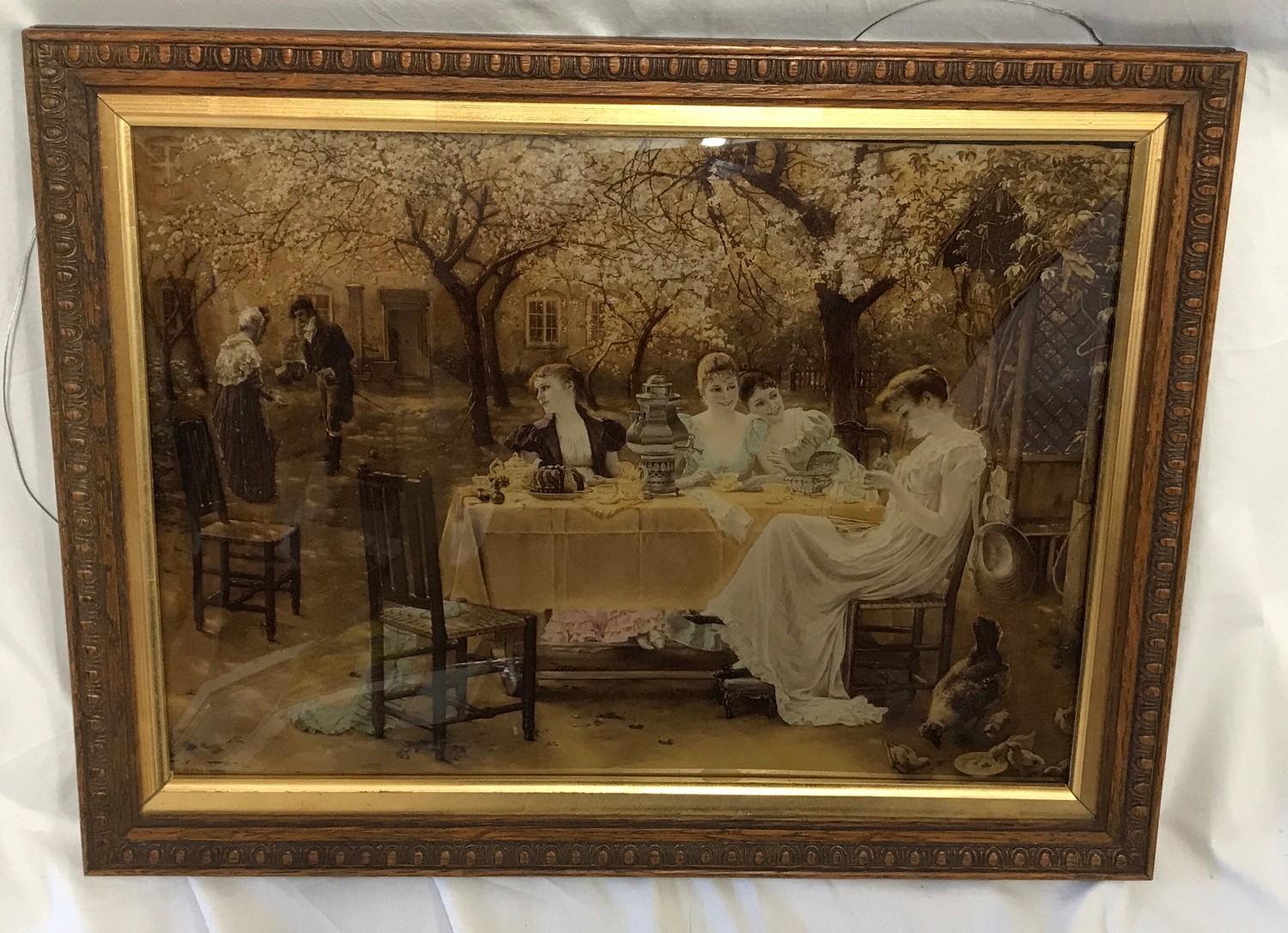 Oak framed Crystoleum of an afternoon garden tea party. Crystoleum size approx 27cms h x 38cms w,