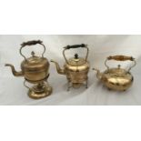 Two brass spirit burning kettles and another brass kettle with an amber glass handle. Spirit kettles