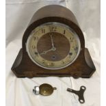 Oak mantle clock, Westminster chimes with key, 22cms h x 29cms w.Condition ReportAdded bolt weight