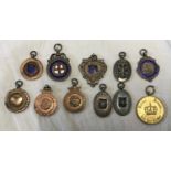 A collection of hallmarked silver fob pendants to include enamelled and gold plate, 1930's