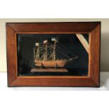 A deep cased wooden three mast ship model made by a German prisoner of war at the Frongoch