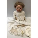 A German pot headed doll with a composite body and a number stamped to the back - 263.38 Germany.