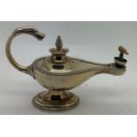 A hallmarked silver novelty table lighter formed as an oil lamp. Birmingham 1912.15cms l x 9.5cms h.