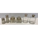 A pair of silver topped glass ink wells, H.M. Birmingham 1897, a pair of silver topped bottles W and