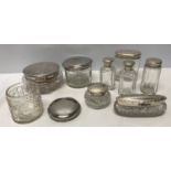 A selection of hallmarked silver topped glass dressing table jars, Various makers. Approx. 170gms.