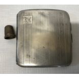 A silver cigarette case with engine turned decoration F.F Birmingham 1929 and a small silver thimble