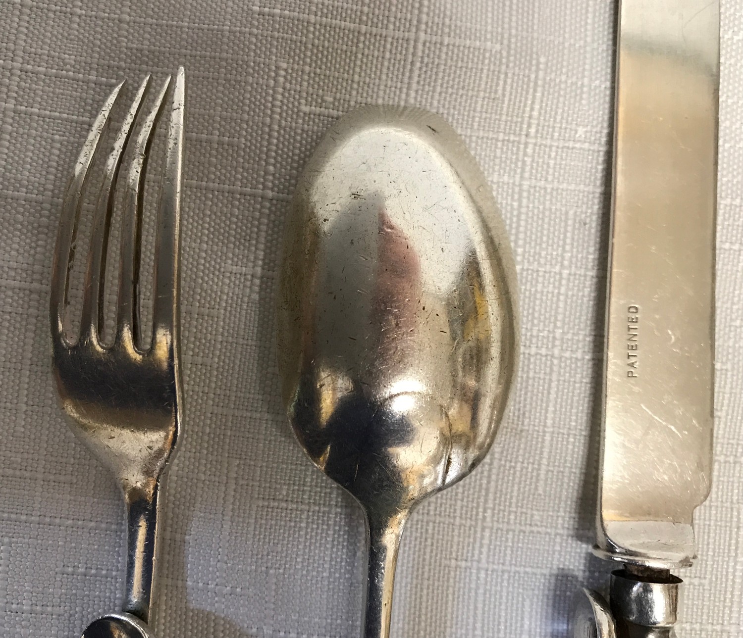 A Silver cutlery set, Sheffield 1910 L BRS Ltd with ergonomic design possibly for infants due to - Image 3 of 5
