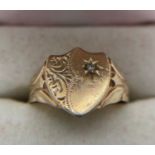 A 9ct yellow gold shield shaped signet ring set with diamond. Size U. 2.6gms.