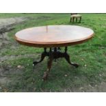 Victorian walnut inlaid oval tip top table with carved base and pot castors. 129cm x 97cm, approx