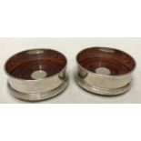 Pair of hallmarked silver coasters with mahogany base B and Co. 925 Birmingham 1977. 9.5cms w.