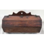 An oak wall mounted candle box in a hexagon shape with leather strap hinges,. 24.5cm w x 12cm h.