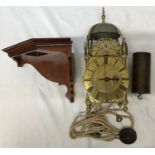 An old reproduction lantern clock with pulley, weight and wooden corner mounted shelf. A single poin