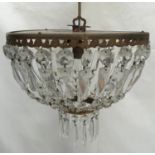 A small two tiered chandelier with symmetrical cut glass pendants. To take a single bulb. 30cm w x