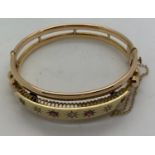 A Victorian bracelet set with 4 rubies and 3 diamonds. 21.5gms.Condition ReportSlight dent to back.