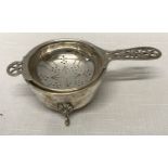 A hallmarked silver tea strainer and bowl stand. A. E. & P. Co. Ltd Sheffield 1947. Strainer 13cms