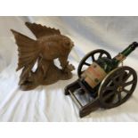 A wooden carved Goldfish 35cms h and a empty Courvoisier Cognac V.S.O.P mounted on a wood and