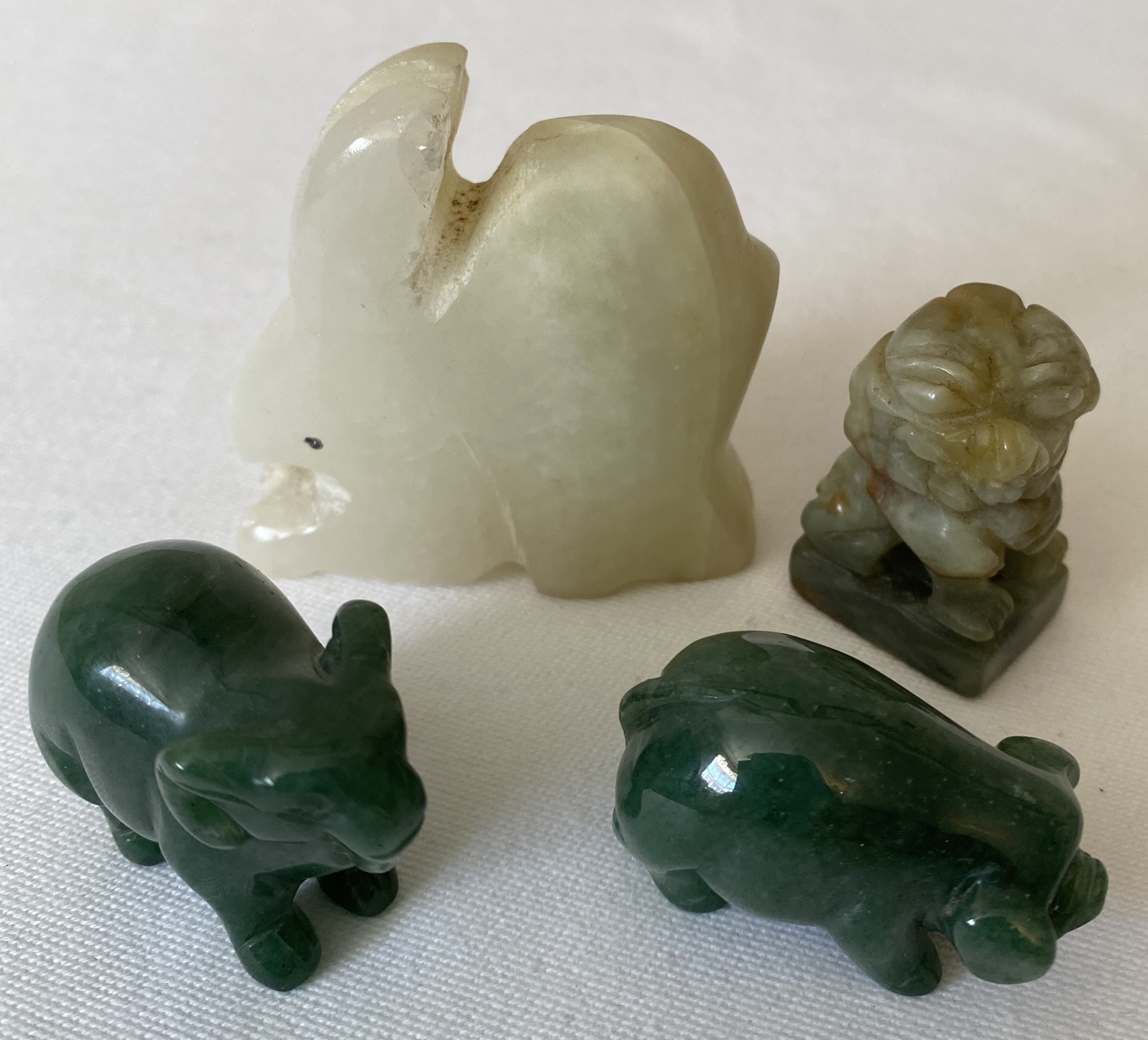Four various green stone animals to include pig , elephant, rabbit and dog of fo. Rabbit 5.5cms h.
