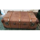 A large wood bound brown canvas travel trunk made by PAKAWA England with fitted tray interior. 94cms