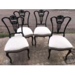 Set of four late Victorian dark walnut carved back dining chairs with cabriole legs. Height to