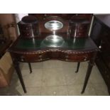 A late Victorian mahogany ladies writing desk with leather to top and an oval mirrored back. 91cm