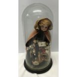 A good example of a Victorian pedlar doll on a circular ebonised base under a glass dome. Doll