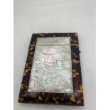 A tortoiseshell and mother of pearl visiting card case. Mother of pearl engraved with peacock and