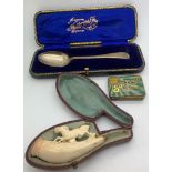 A cased silver spoon marked Fattorini and Sons, Bradford, a Meerschaum cheroot holder in a fitted