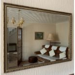 An oblong bevel edged wall mirror. 83cm x 110cm.