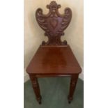 A 19thC mahogany hall chair with shield back. 81cms h.Condition ReportGood condition, signs of old