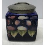 A Tudric pewter mounted dark blue pansy design square biscuit barrel. lid marked H, made in England,