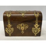 A Victorian tea caddy in walnut with brass embellishments and 2 lidded compartments inside. 23cm l x