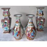 A garniture of four 19thC Chinese famille rose Mandarin pattern tallest 23cms h.Condition