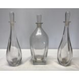 Three Mid Century heavy glass decanters with indistinct marks to base. A pair with raindrop shape